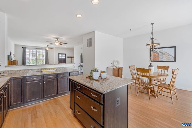 1254 Haden Pl, Crozet, VA 22932 - kitchen featuring light wood-style floors, dark brown cabinets, a ceiling fan, recessed lighting, and decorative light fixtures