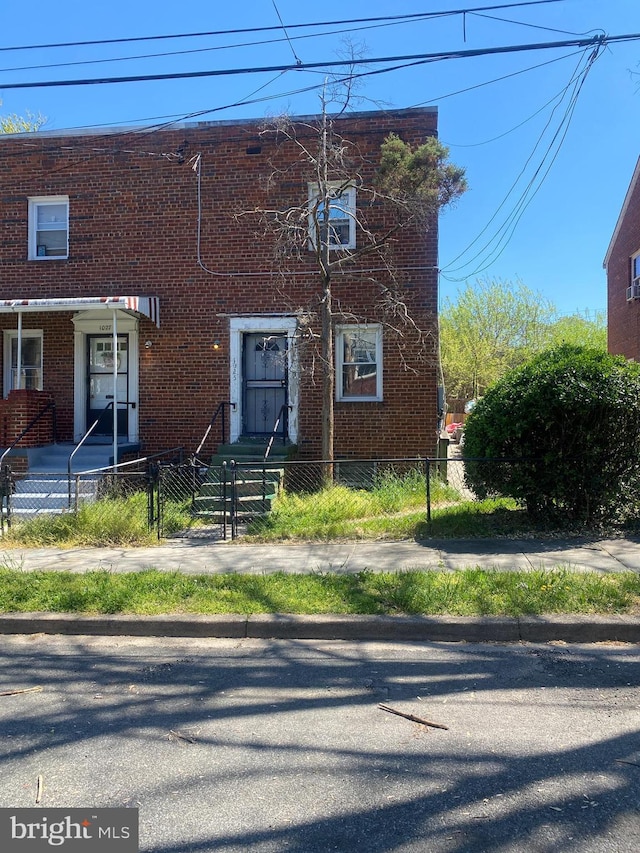 1025 47th Pl NE, Washington, DC 20019 - view of front facade featuring a fenced front yard, brick siding, and a gate
