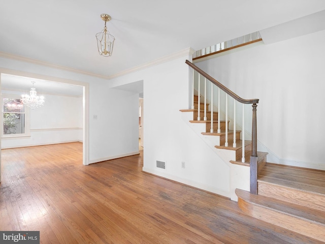 407 Owls Nest Rd, Wilmington, DE 19807 - stairway with a chandelier, hardwood / wood-style flooring, and ornamental molding