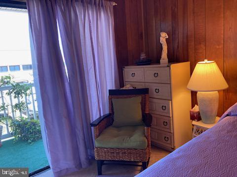 718 Mooring Rd Unit B203, Ocean City, MD 21842 - bedroom featuring wood walls