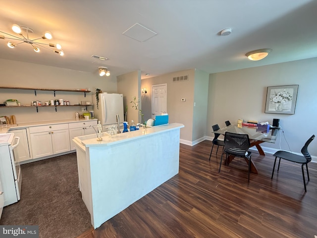 1545 Russett Dr, Warminster, PA 18974 - kitchen featuring white appliances, open shelves, dark wood-style flooring, an island with sink, and light countertops
