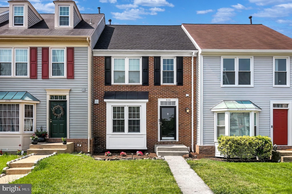 21196 Winding Brook Sq, Ashburn, VA 20147 - multi unit property featuring brick siding, a front lawn, entry steps, and roof with shingles