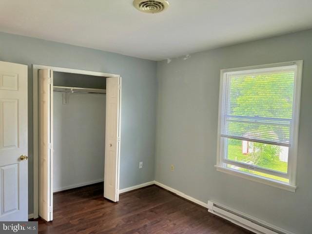 56 W Bishop Ln, Smithsburg, MD 21783 - unfurnished bedroom with a baseboard heating unit, dark wood-style floors, and a closet