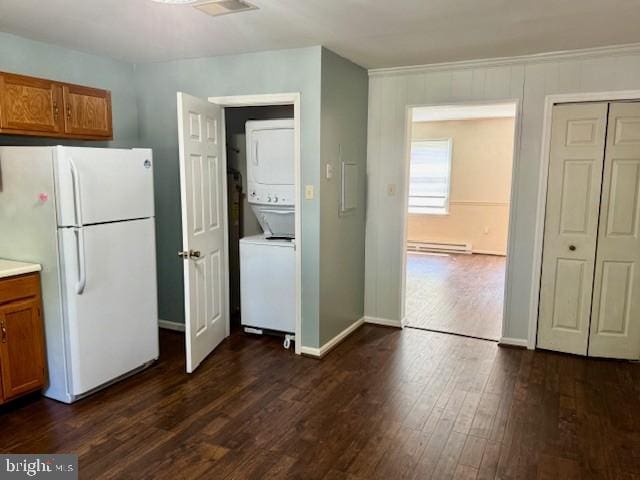 56 W Bishop Ln, Smithsburg, MD 21783 - kitchen with freestanding refrigerator, estacked washer and dryer, a baseboard heating unit, brown cabinetry, and dark wood-style flooring