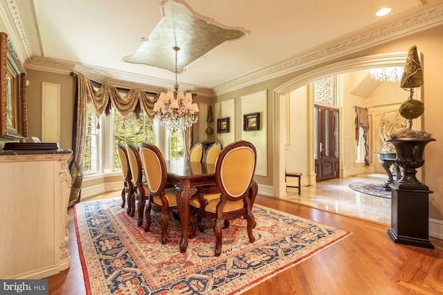 3500 Windy Bush Rd, New Hope, PA 18938 - dining area with a chandelier, arched walkways, wood finished floors, and crown molding