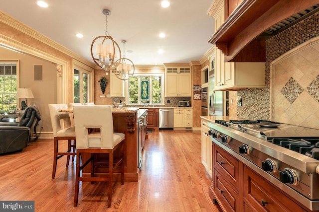 3500 Windy Bush Rd, New Hope, PA 18938 - kitchen with appliances with stainless steel finishes, premium range hood, a kitchen breakfast bar, a chandelier, and healthy amount of natural light