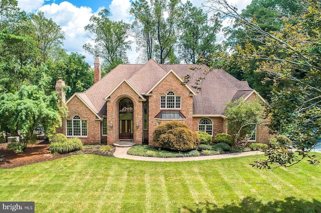 3500 Windy Bush Rd, New Hope, PA 18938 - traditional home with a front yard, brick siding, a chimney, and a shingled roof