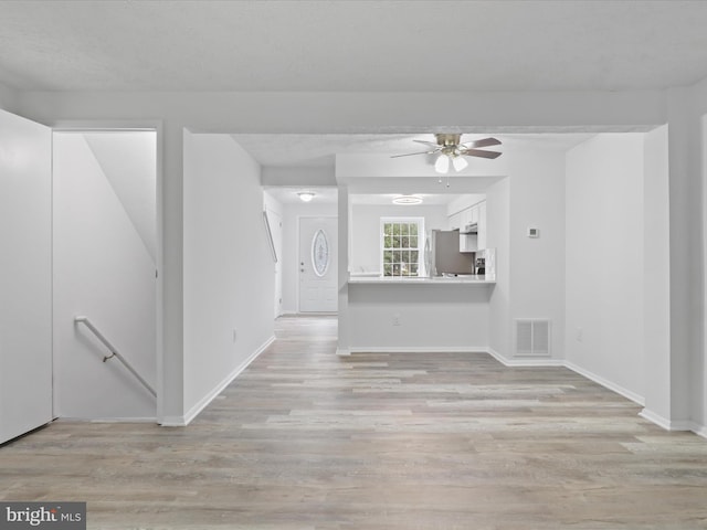 8456 Rocky Knob Ct, Lorton, VA 22079 - unfurnished living room featuring a ceiling fan and light wood-style floors