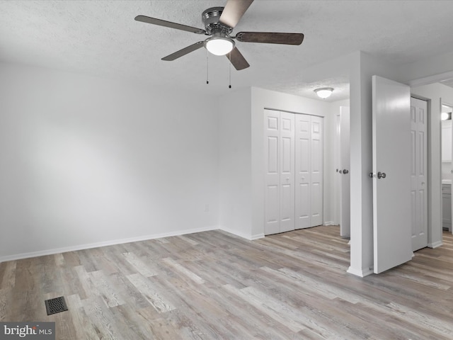 8456 Rocky Knob Ct, Lorton, VA 22079 - unfurnished room with ceiling fan, light wood-style floors, and a textured ceiling