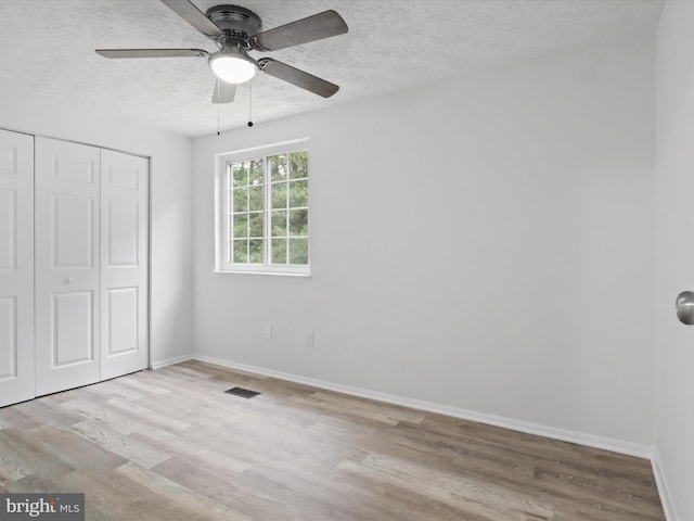 8456 Rocky Knob Ct, Lorton, VA 22079 - unfurnished bedroom with a textured ceiling, wood finished floors, a closet, and a ceiling fan