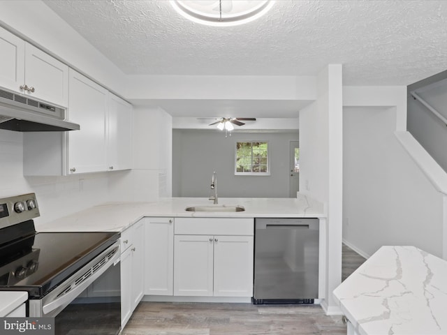 8456 Rocky Knob Ct, Lorton, VA 22079 - kitchen with appliances with stainless steel finishes, under cabinet range hood, light wood-style floors, a textured ceiling, and white cabinetry