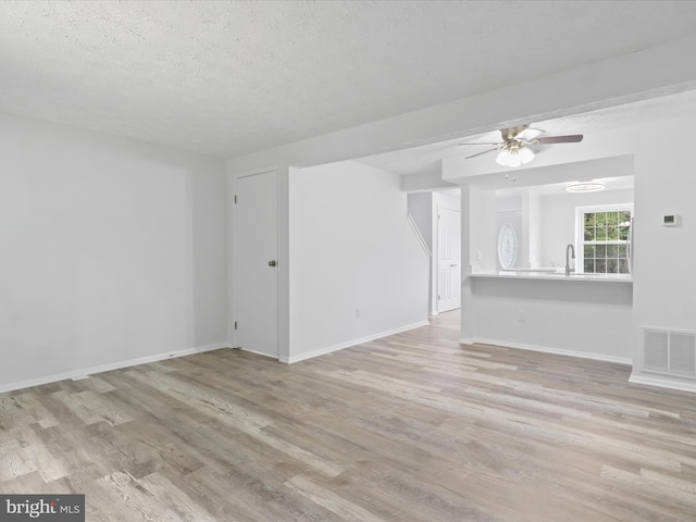 8456 Rocky Knob Ct, Lorton, VA 22079 - unfurnished living room featuring wood finished floors, a ceiling fan, and a textured ceiling