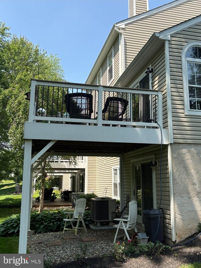 3307 Freemans Ln, Holland, PA 18966 - rear view of house with a chimney, a deck, and a patio area