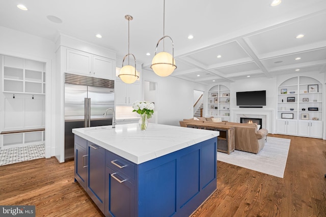 3433 N Edison St, Arlington, VA 22207 - kitchen with blue cabinetry, built in features, a kitchen island with sink, a fireplace, and white cabinetry