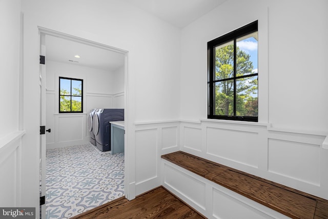 3433 N Edison St, Arlington, VA 22207 - mudroom featuring washer and clothes dryer, a decorative wall, and wainscoting