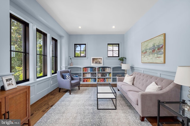 3433 N Edison St, Arlington, VA 22207 - living area with wood finished floors, healthy amount of natural light, a decorative wall, recessed lighting, and a wainscoted wall