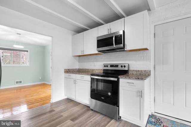 7012 Nashville Ct, Lanham, MD 20706 - kitchen with stainless steel appliances, white cabinets, decorative backsplash, and light wood-type flooring