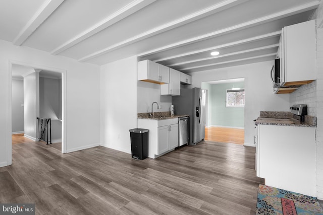 7012 Nashville Ct, Lanham, MD 20706 - kitchen with stainless steel appliances, dark stone countertops, dark wood-type flooring, white cabinetry, and beamed ceiling