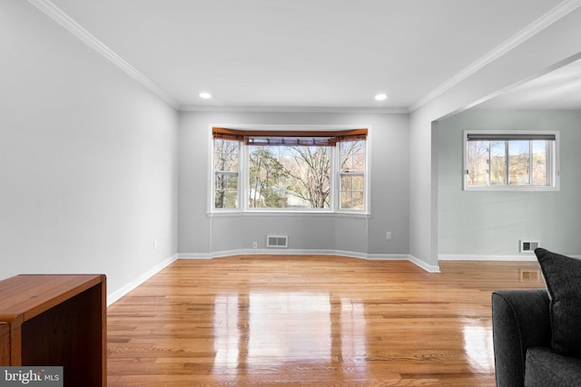 7012 Nashville Ct, Lanham, MD 20706 - unfurnished living room featuring plenty of natural light, light wood-style flooring, crown molding, and recessed lighting