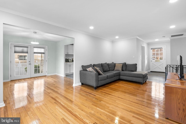 7012 Nashville Ct, Lanham, MD 20706 - living room with light wood-type flooring, healthy amount of natural light, recessed lighting, ornamental molding, and french doors