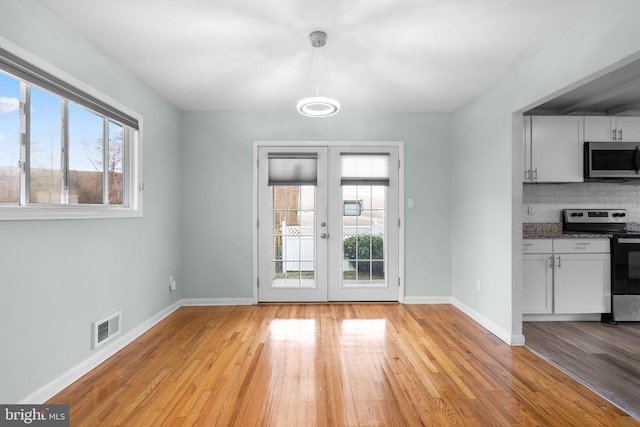 7012 Nashville Ct, Lanham, MD 20706 - unfurnished dining area with plenty of natural light, light wood-style flooring, and french doors