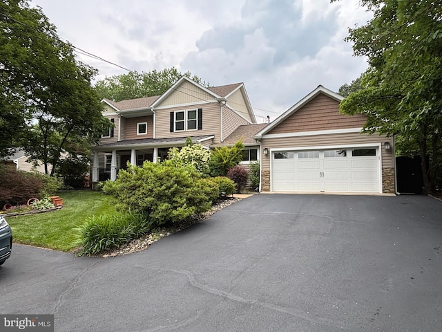 3814 Estel Rd, Fairfax, VA 22031 - traditional-style home featuring asphalt driveway, a garage, a front yard, and stone siding