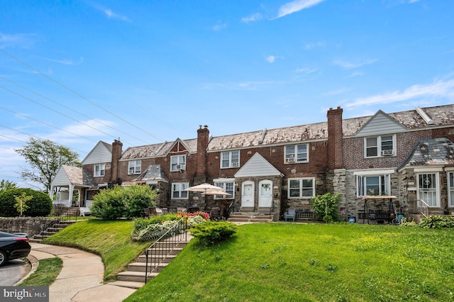246 Le Carra Dr, Lansdowne, PA 19050 - view of property with a high end roof, a front lawn, a chimney, stone siding, and entry steps