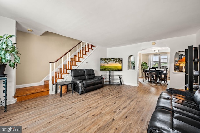246 Le Carra Dr, Lansdowne, PA 19050 - living area featuring arched walkways, wood finished floors, and stairway