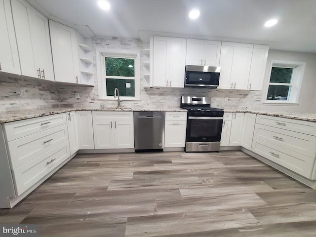 258 Ridge Rd, Browns Mills, NJ 08015 - kitchen with stainless steel appliances, open shelves, white cabinetry, recessed lighting, and decorative backsplash