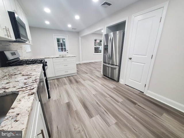 258 Ridge Rd, Browns Mills, NJ 08015 - kitchen with appliances with stainless steel finishes, white cabinetry, light wood finished floors, light stone countertops, and recessed lighting