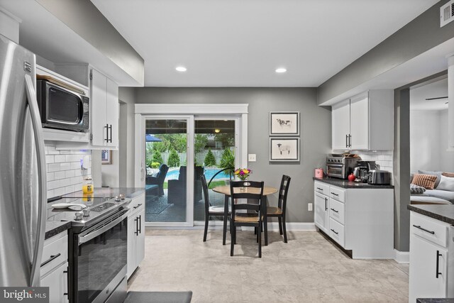 47 Sherwood Ln, Westampton, NJ 08060 - kitchen with appliances with stainless steel finishes, dark countertops, white cabinetry, backsplash, and recessed lighting