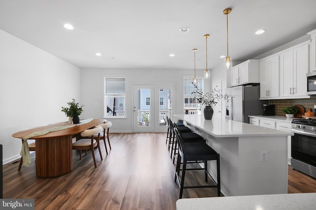 1025 Overlook Way, Laurel, MD 20707 - kitchen featuring appliances with stainless steel finishes, recessed lighting, decorative backsplash, wood finished floors, and a center island
