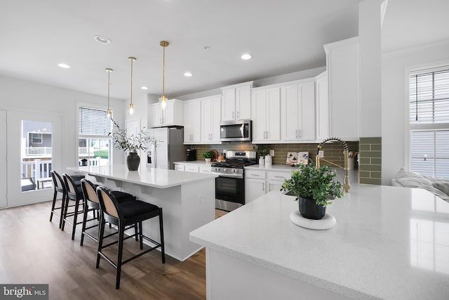 1025 Overlook Way, Laurel, MD 20707 - kitchen featuring appliances with stainless steel finishes, a kitchen breakfast bar, tasteful backsplash, dark wood-type flooring, and recessed lighting