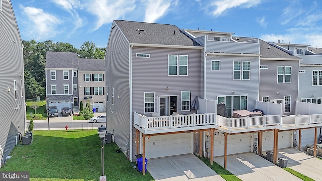 1025 Overlook Way, Laurel, MD 20707 - back of house featuring concrete driveway, a garage, a yard, and a residential view