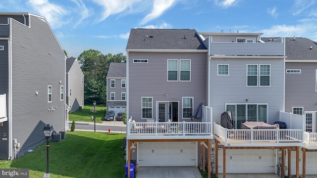 1025 Overlook Way, Laurel, MD 20707 - back of house featuring an attached garage, a yard, driveway, a wooden deck, and a shingled roof