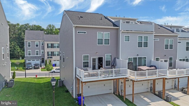 1025 Overlook Way, Laurel, MD 20707 - rear view of property with concrete driveway, an attached garage, and a lawn