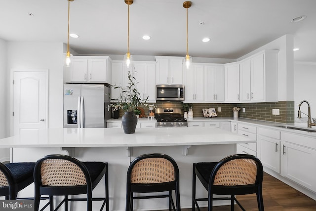 1025 Overlook Way, Laurel, MD 20707 - kitchen with stainless steel appliances, white cabinetry, decorative backsplash, a breakfast bar area, and recessed lighting