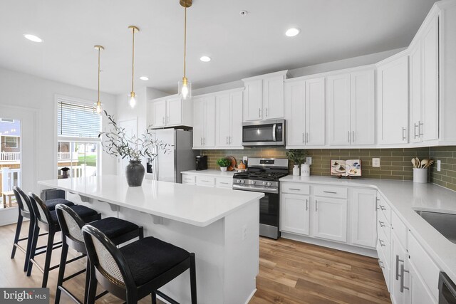 1025 Overlook Way, Laurel, MD 20707 - kitchen featuring stainless steel appliances, wood finished floors, tasteful backsplash, a center island, and recessed lighting