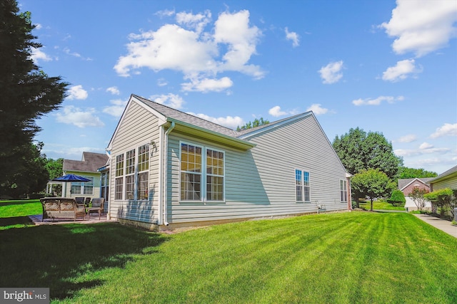16916 Four Seasons Dr, Dumfries, VA 22025 - view of side of home featuring a lawn, outdoor lounge area, and a patio
