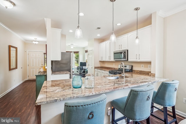16916 Four Seasons Dr, Dumfries, VA 22025 - kitchen with appliances with stainless steel finishes, a peninsula, light stone counters, dark wood-style flooring, and white cabinets