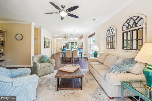 16916 Four Seasons Dr, Dumfries, VA 22025 - living area with crown molding, wood finished floors, a chandelier, and ceiling fan