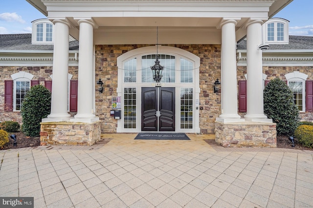 16916 Four Seasons Dr, Dumfries, VA 22025 - view of exterior entry with stone siding and a shingled roof