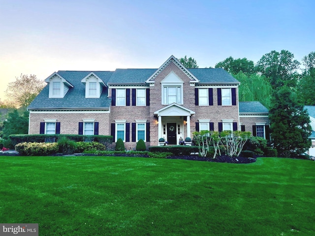 11910 Crayton Ct, Herndon, VA 20170 - colonial-style house featuring a front lawn, brick siding, and roof with shingles