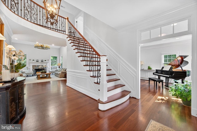 11910 Crayton Ct, Herndon, VA 20170 - entrance foyer featuring stairway, a chandelier, a decorative wall, wood finished floors, and healthy amount of natural light