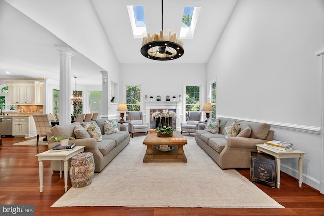 11910 Crayton Ct, Herndon, VA 20170 - living area with a chandelier, a skylight, wood finished floors, and high vaulted ceiling