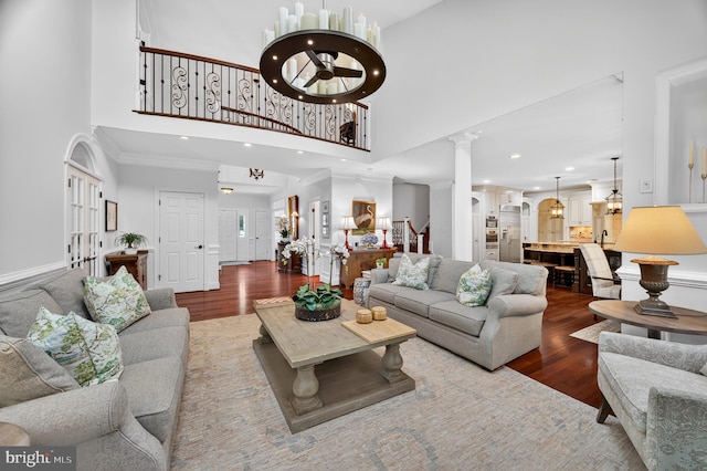 11910 Crayton Ct, Herndon, VA 20170 - living area with a high ceiling, wood finished floors, decorative columns, recessed lighting, and ornamental molding