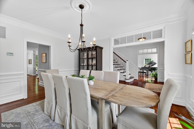 11910 Crayton Ct, Herndon, VA 20170 - dining space with a chandelier, stairs, wood finished floors, a decorative wall, and ornamental molding
