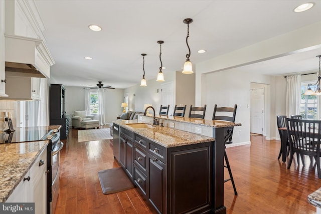 5790 Cedar Glen Dr, Narvon, PA 17555 - kitchen with appliances with stainless steel finishes, a breakfast bar, a ceiling fan, dark wood-style floors, and open floor plan