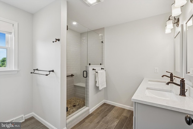 5790 Cedar Glen Dr, Narvon, PA 17555 - bathroom featuring double vanity, a shower stall, and wood finished floors
