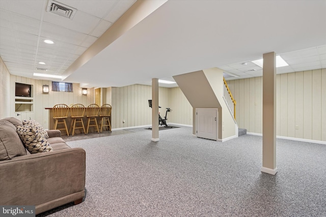 5790 Cedar Glen Dr, Narvon, PA 17555 - carpeted living room featuring a paneled ceiling, a dry bar, stairway, and wood walls